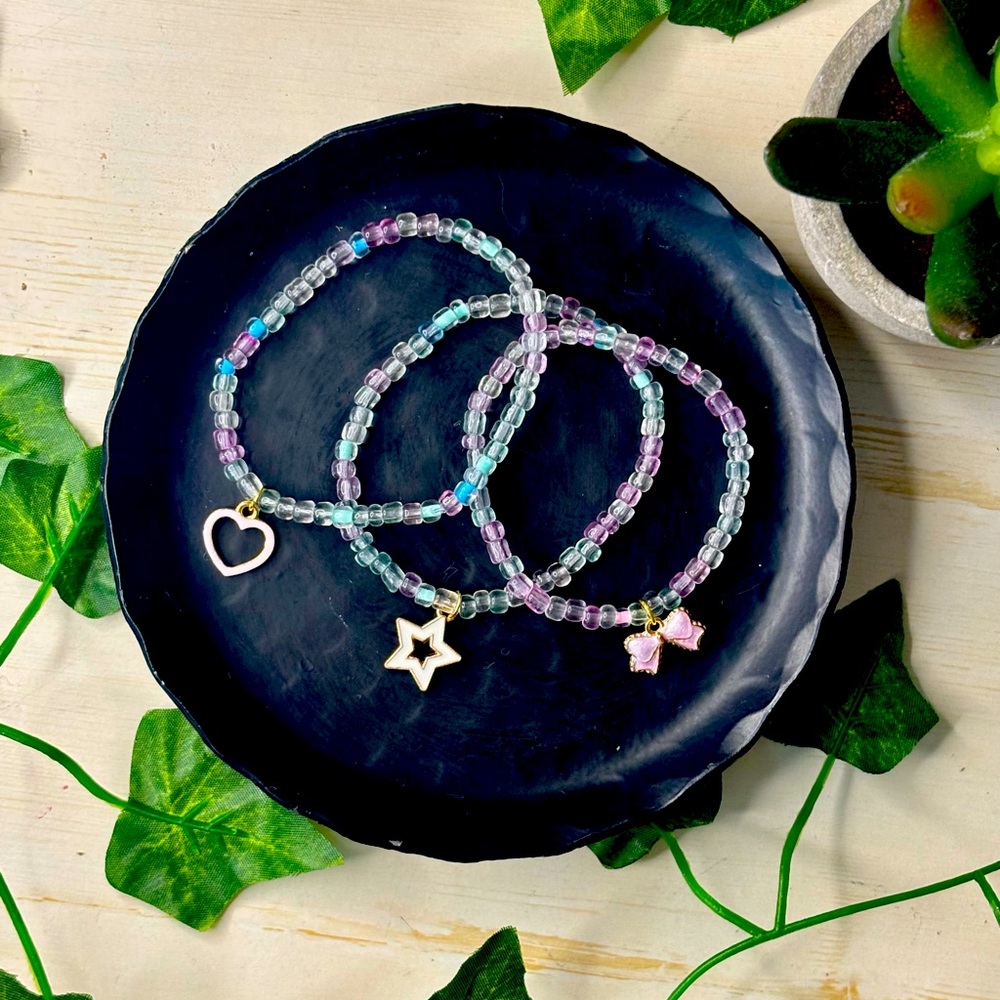 Cute blue, pink and teal, clear bead bracelet with random charm
